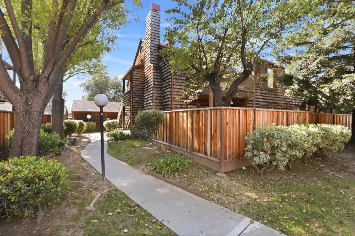 1555 Hecker Pass Road, Unit H102 Gilroy, CA 95020 - Photo 27 of 34 a view of a garden with wooden fence