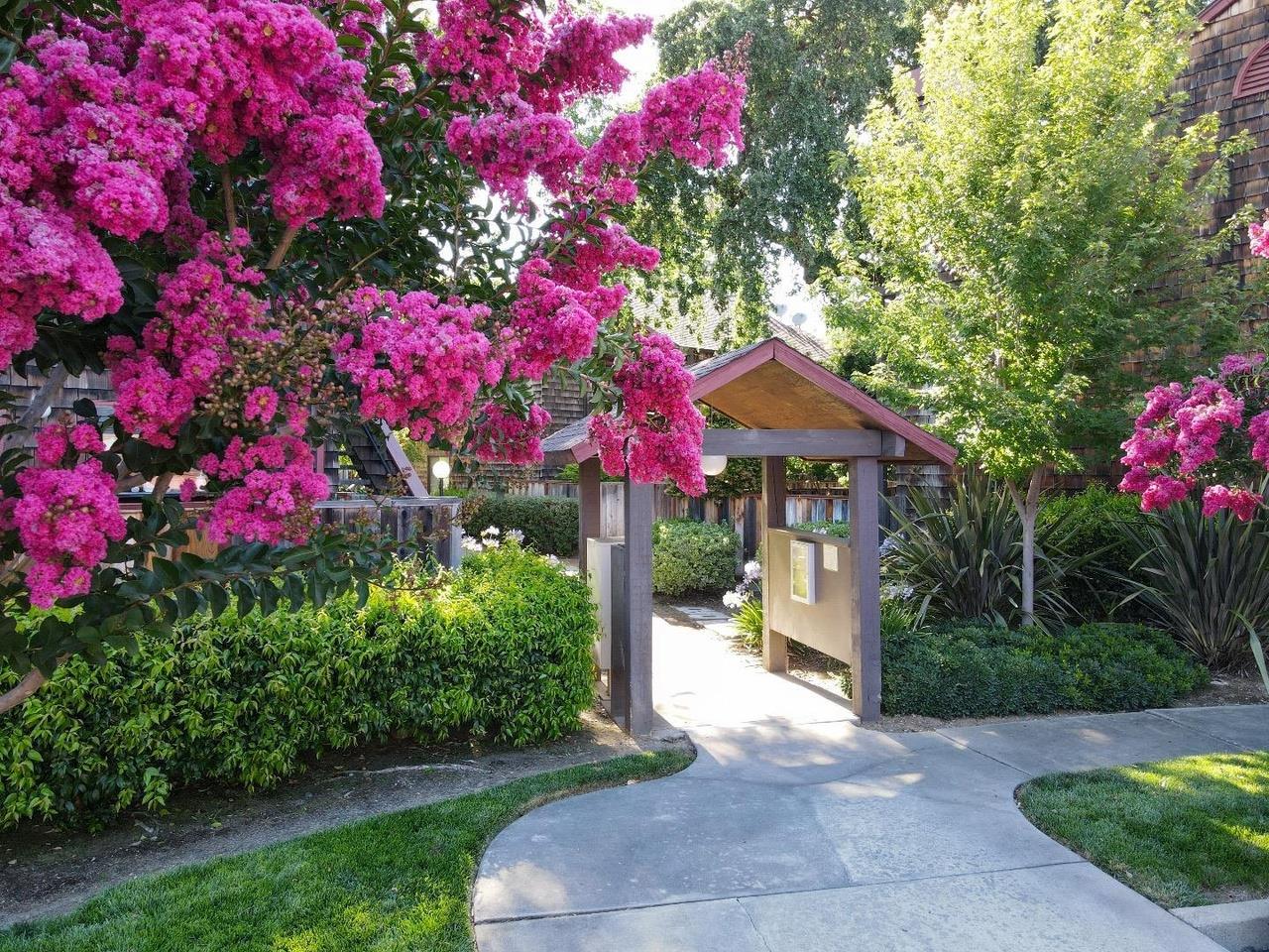 1555 Hecker Pass Road, Unit H102 Gilroy, CA 95020 - Photo 30 of 34 a front view of a house with a yard and fountain