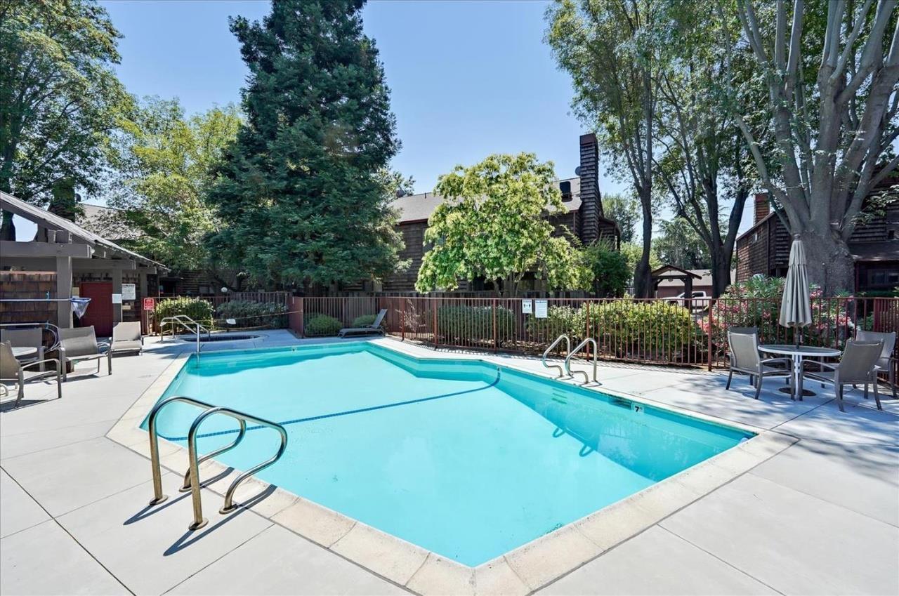 1555 Hecker Pass Road, Unit H102 Gilroy, CA 95020 - Photo 32 of 34 a view of a swimming pool with chairs
