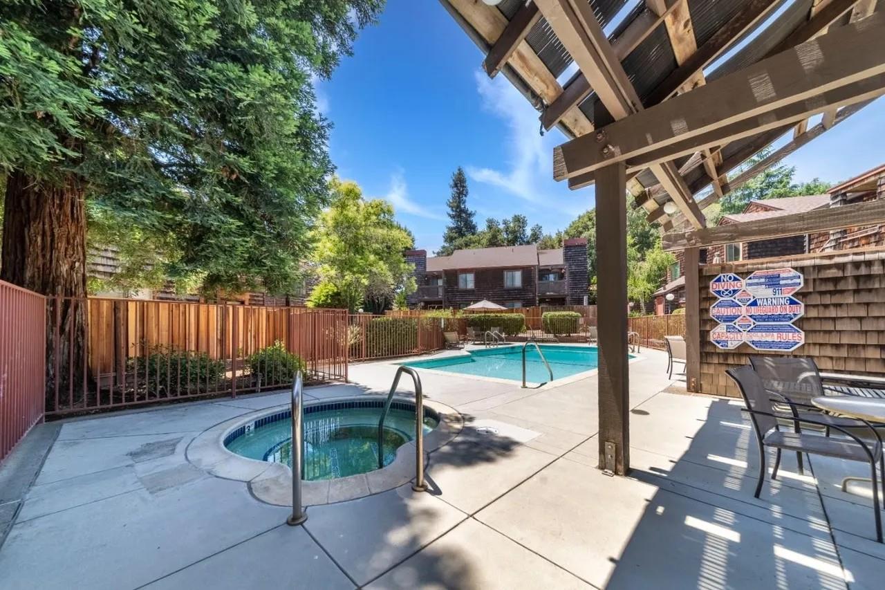 1555 Hecker Pass Road, Unit H102 Gilroy, CA 95020 - Photo 33 of 34 a view of a patio with a table and chairs