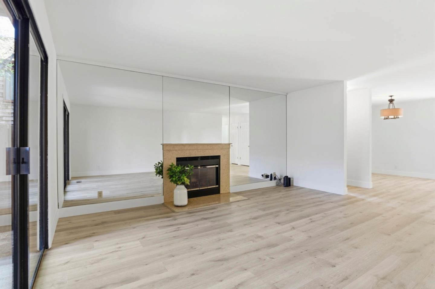 1555 Hecker Pass Road, Unit H102 Gilroy, CA 95020 - Photo 4 of 34 a view of an empty room with a fireplace and a window