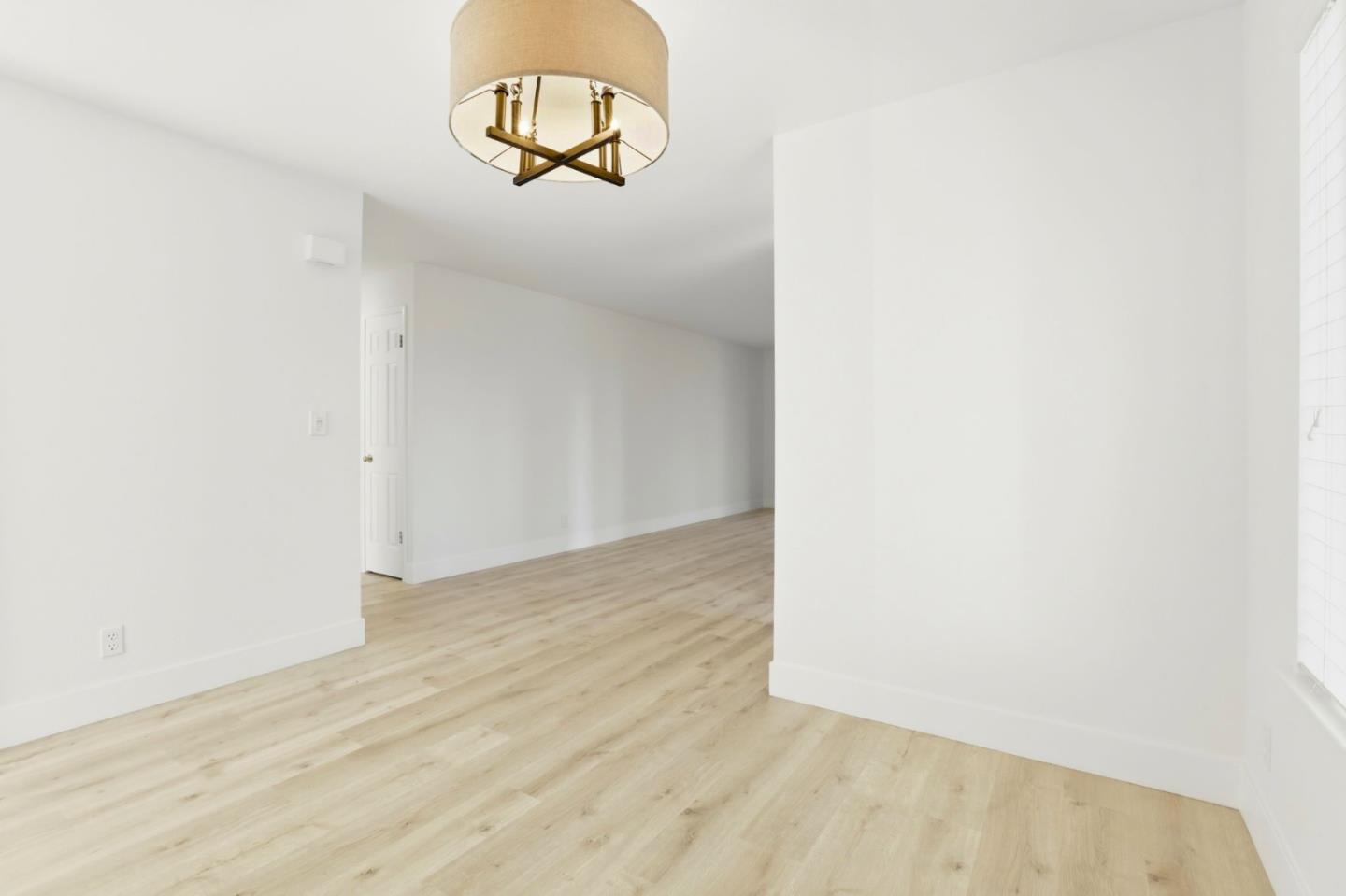 1555 Hecker Pass Road, Unit H102 Gilroy, CA 95020 - Photo 7 of 34 a view of a room with wooden floor