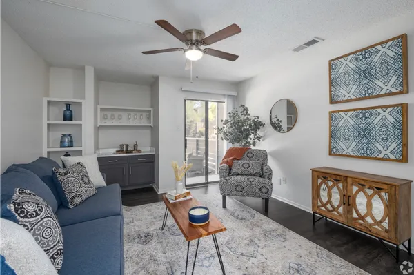 a living room with furniture a rug and a window