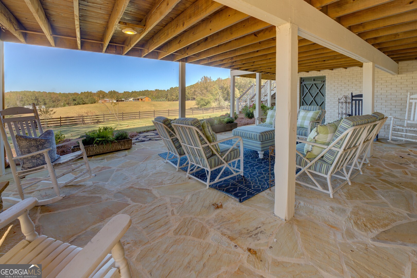 419 Parker Road McDonough, GA 30252 - Photo 103 of 115 a view of a patio with a table and chairs next to a yard