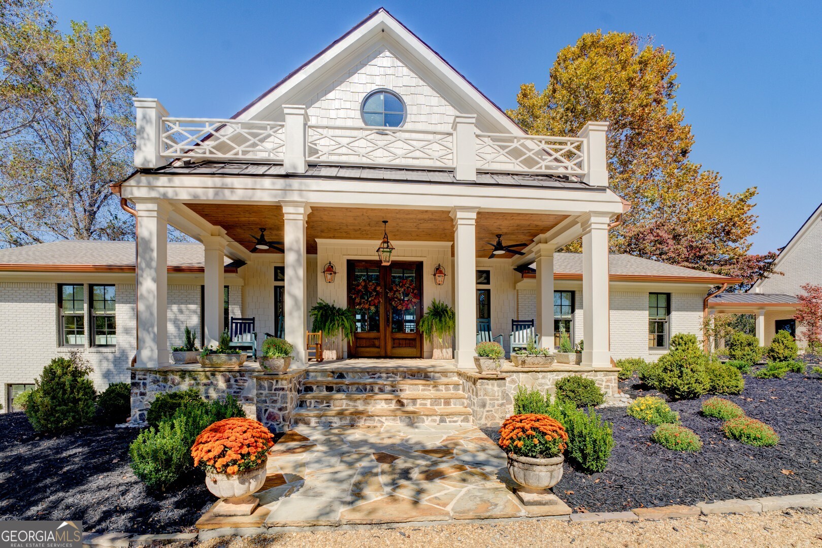 419 Parker Road McDonough, GA 30252 - Photo 2 of 115 a view of a white house with potted plants and a dining table