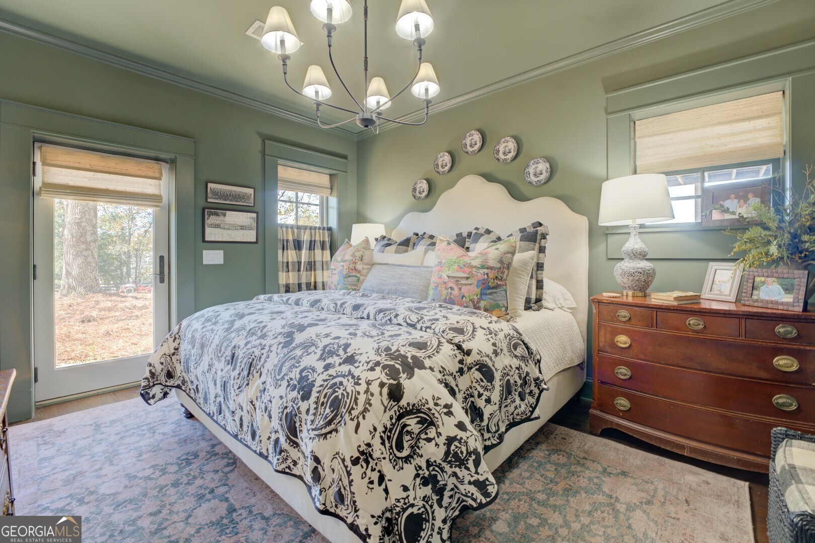 419 Parker Road McDonough, GA 30252 - Photo 72 of 115 a bedroom with a large bed and a chandelier