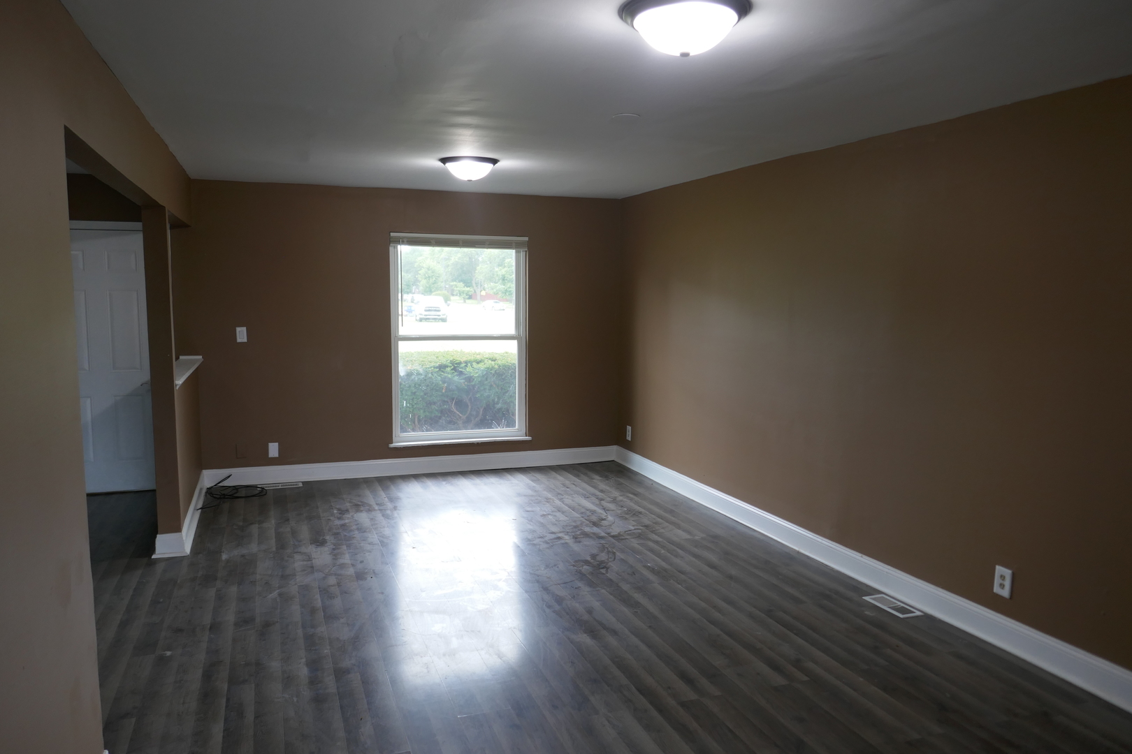 412 Salem Square Bolingbrook, IL 60440 - Photo 3 of 20 an empty room with wooden floor and windows