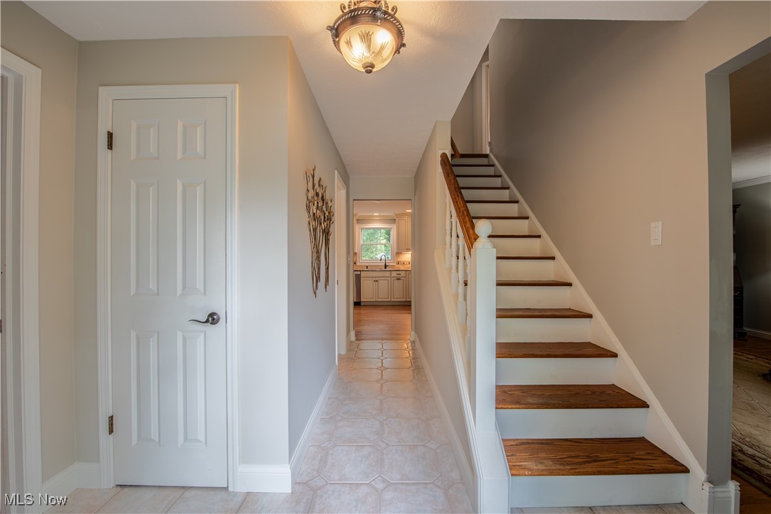 28314 Knickerbocker Road Bay Village, OH 44140 - Photo 8 of 38 Stairs with hardwood / wood-style flooring and sink
