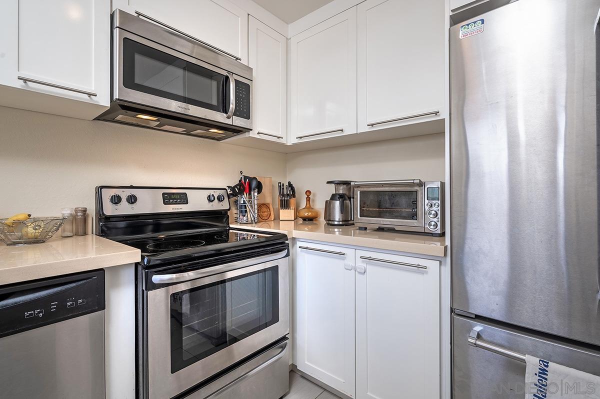 4266 Sixth Avenue San Diego, CA 92103 - Photo 13 of 29 a kitchen with stainless steel appliances granite countertop a stove microwave and sink