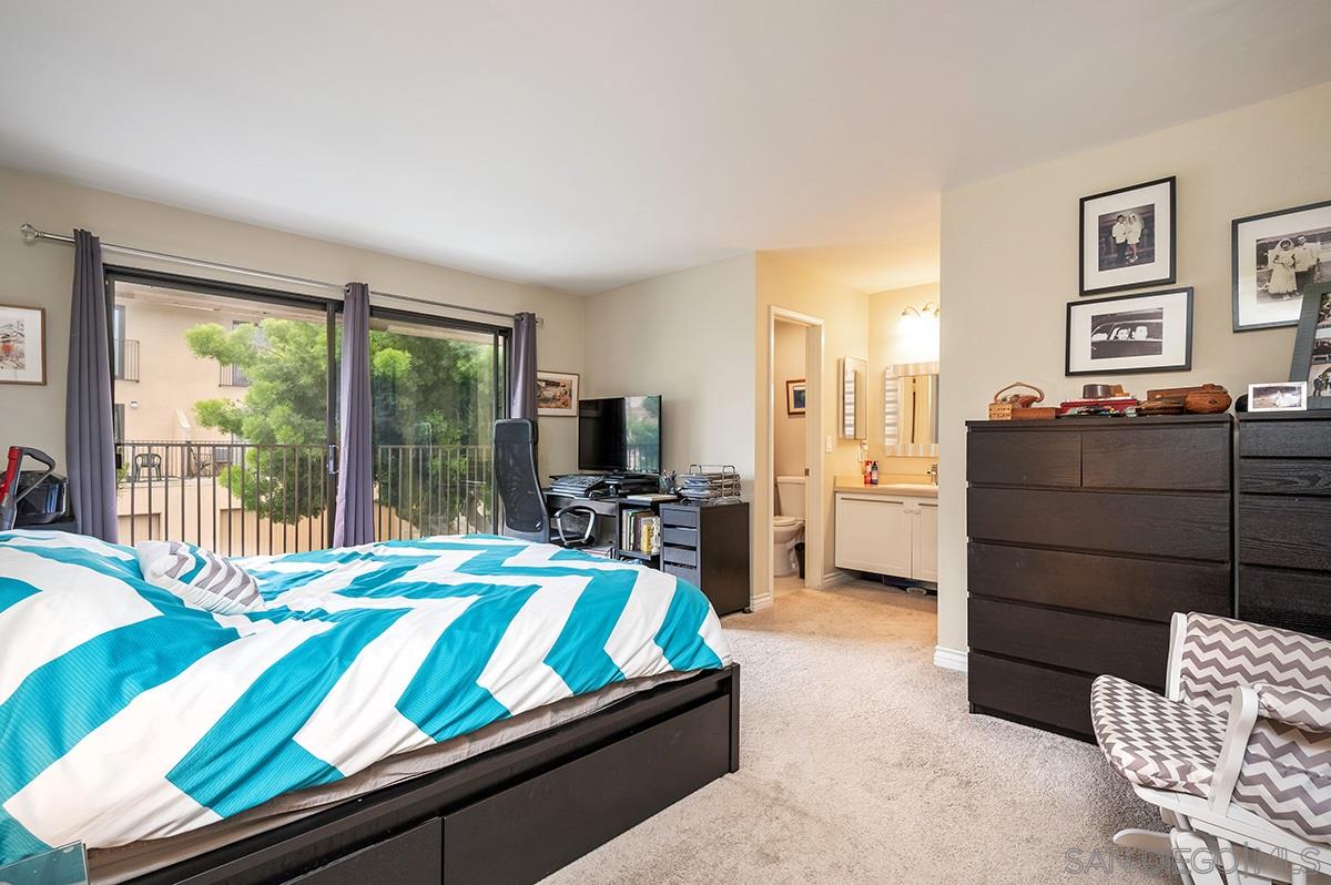 4266 Sixth Avenue San Diego, CA 92103 - Photo 17 of 29 a bedroom with a bed and large windows