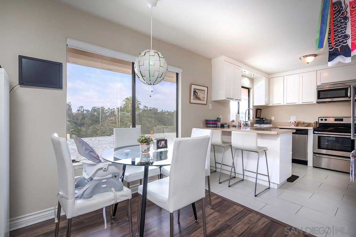 4266 Sixth Avenue San Diego, CA 92103 - Photo 9 of 29 a view of a dining room with furniture a chandelier and wooden floor
