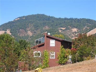 4103 Sonoma Mountain Road Santa Rosa, CA 95404 - Photo 1 of 8 a front view of a house with a yard and mountain view in back