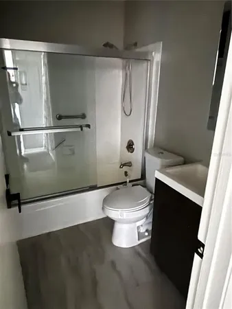 a white toilet sitting next to a bathroom sink