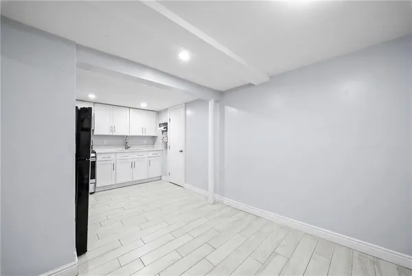 a view of a kitchen with white cabinets