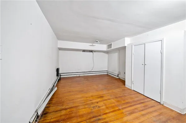 a view of a room with wooden floor