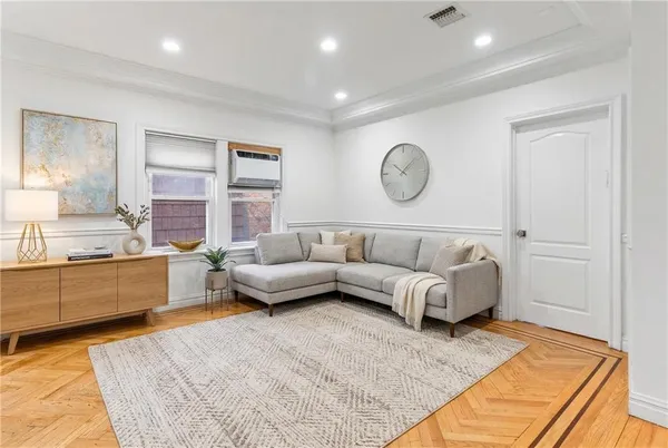 a living room with a couch and cabinets