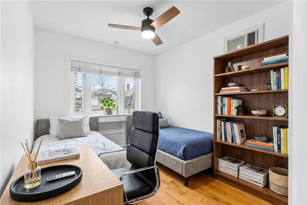 a living room with furniture and a book shelf