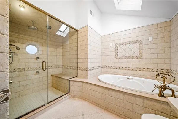 a bathroom with a bathtub and a shower