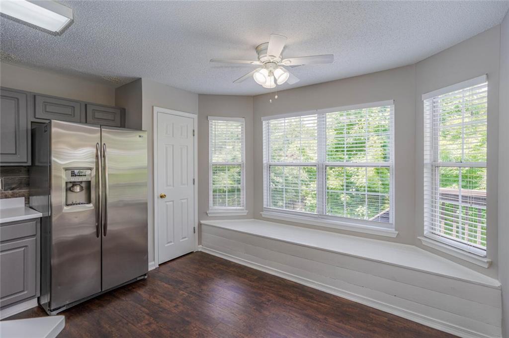 3272 Peach Court Acworth, GA 30101 - Photo 11 of 52 a view of a livingroom with a ceiling fan window and wooden floor