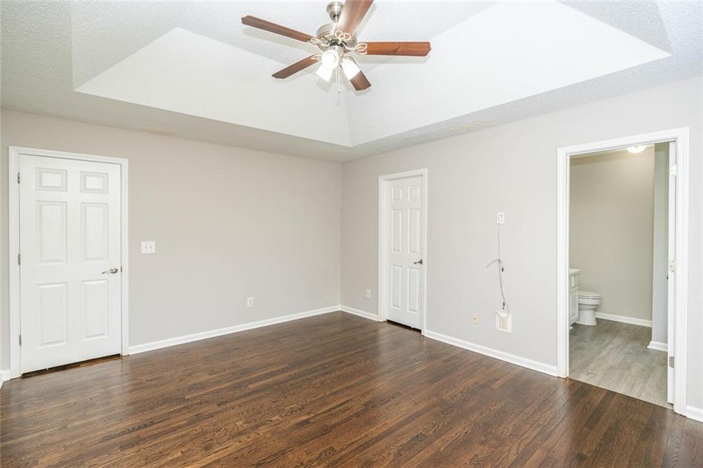 3272 Peach Court Acworth, GA 30101 - Photo 20 of 52 an empty room with wooden floor a ceiling fan and closet