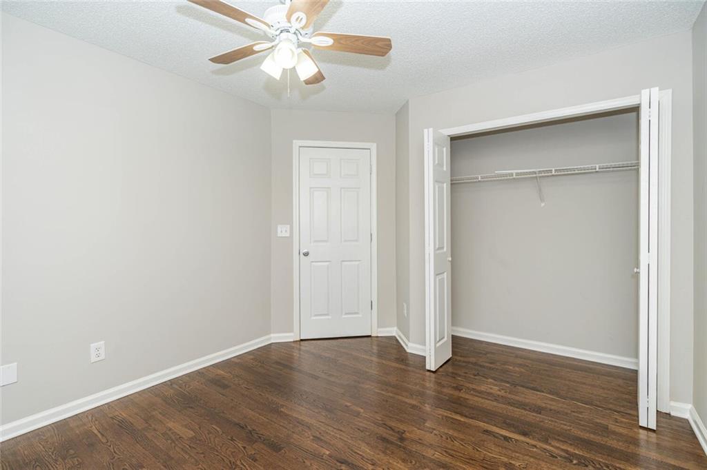 3272 Peach Court Acworth, GA 30101 - Photo 25 of 52 an empty room with wooden floor closet and fan