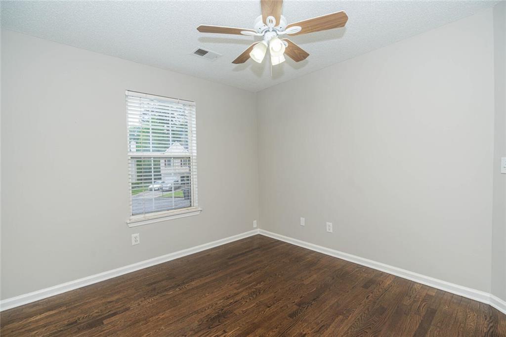 3272 Peach Court Acworth, GA 30101 - Photo 26 of 52 an empty room with wooden floor fan and windows