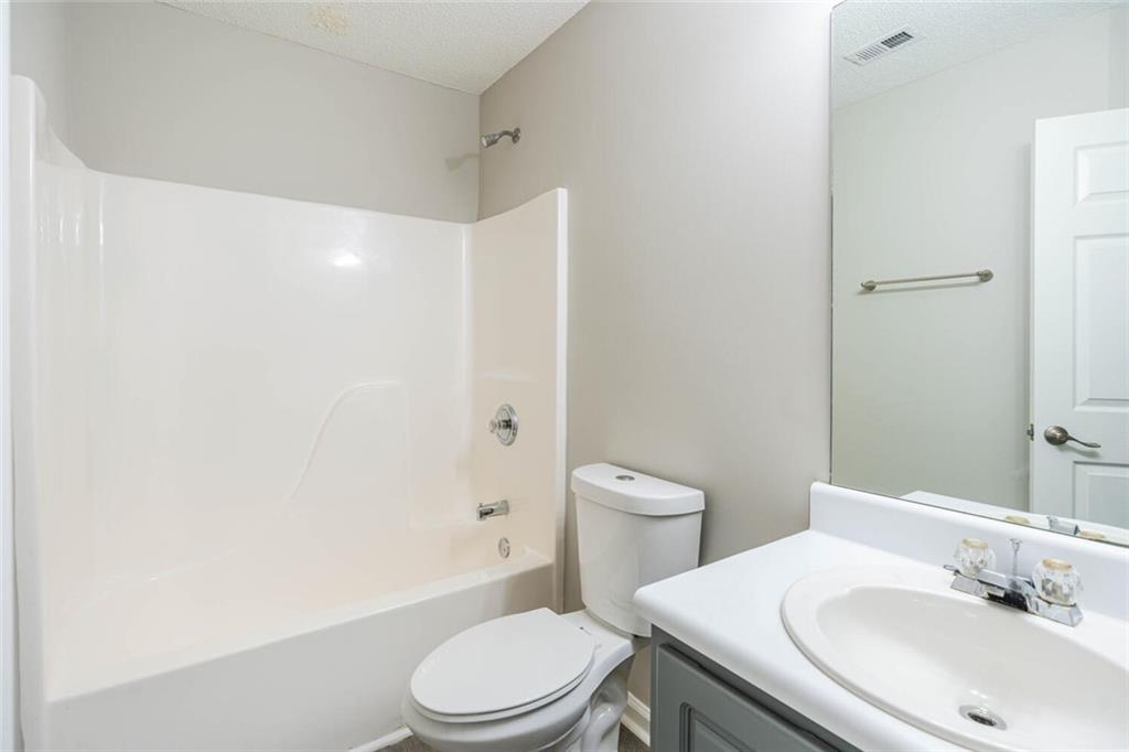 3272 Peach Court Acworth, GA 30101 - Photo 28 of 52 a white toilet sitting next to a bathroom sink