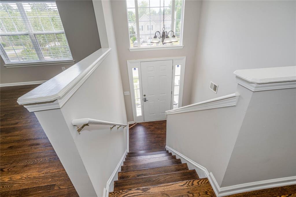 3272 Peach Court Acworth, GA 30101 - Photo 3 of 52 a view of a hallway with wooden floor and staircase