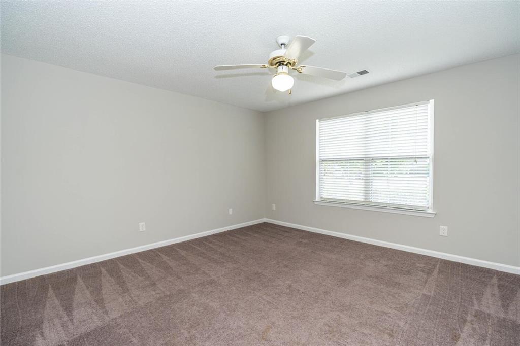 3272 Peach Court Acworth, GA 30101 - Photo 34 of 52 an empty room with windows and chandelier fan