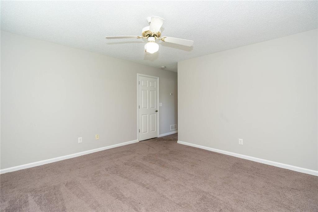 3272 Peach Court Acworth, GA 30101 - Photo 36 of 52 an empty room with a chandelier fan and windows
