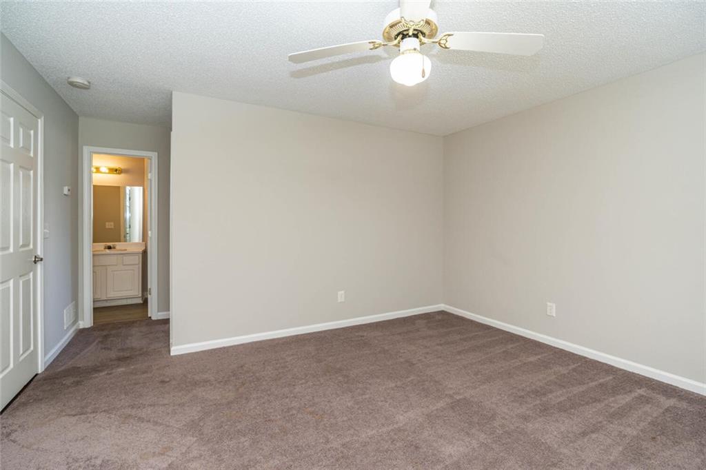 3272 Peach Court Acworth, GA 30101 - Photo 37 of 52 an empty room with a chandelier fan and closet