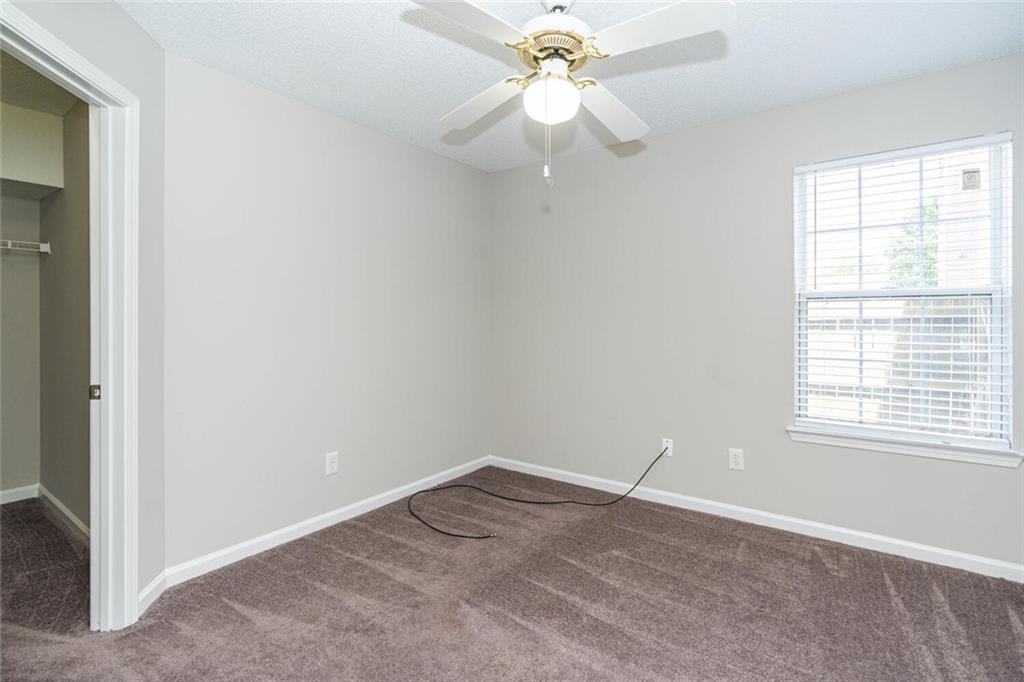 3272 Peach Court Acworth, GA 30101 - Photo 38 of 52 an empty room with a window and a fan