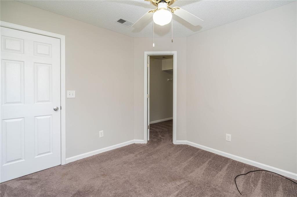3272 Peach Court Acworth, GA 30101 - Photo 39 of 52 an empty room with a chandelier fan