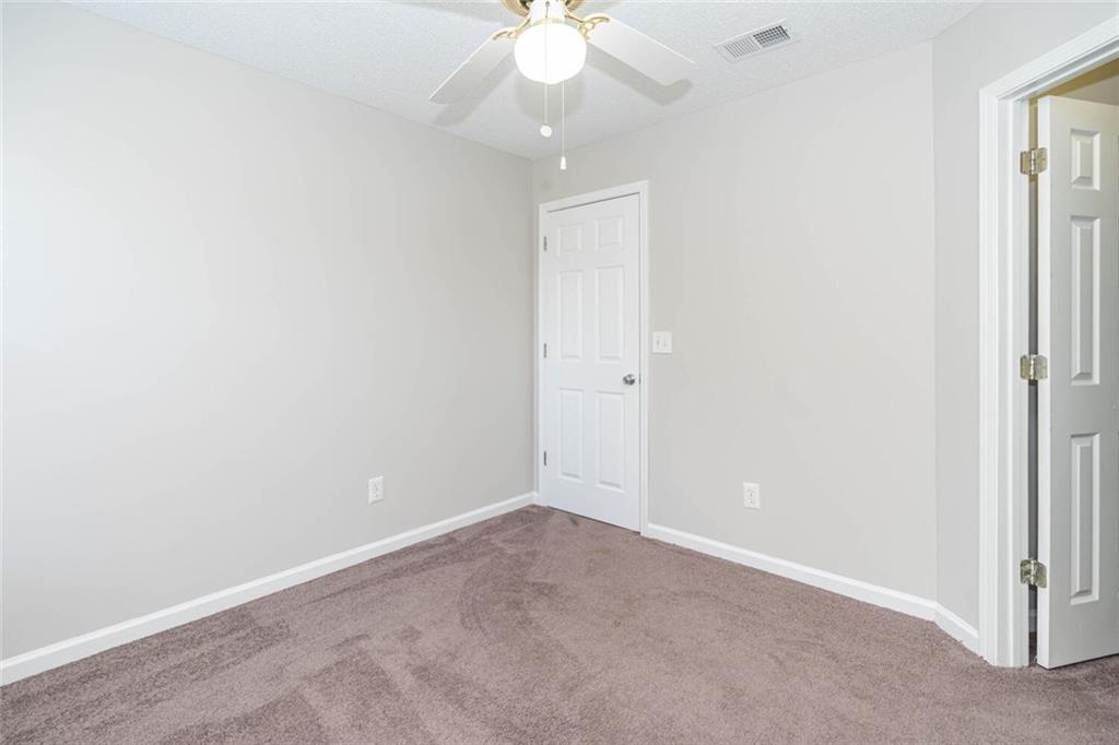 3272 Peach Court Acworth, GA 30101 - Photo 40 of 52 an empty room with a ceiling fan and a window