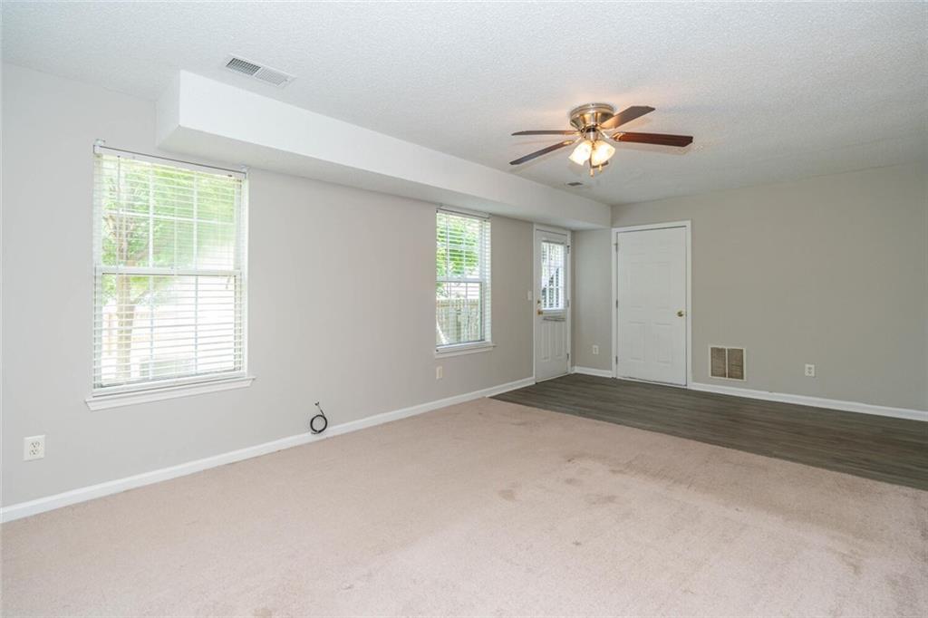 3272 Peach Court Acworth, GA 30101 - Photo 45 of 52 an empty room with windows and ceiling fan
