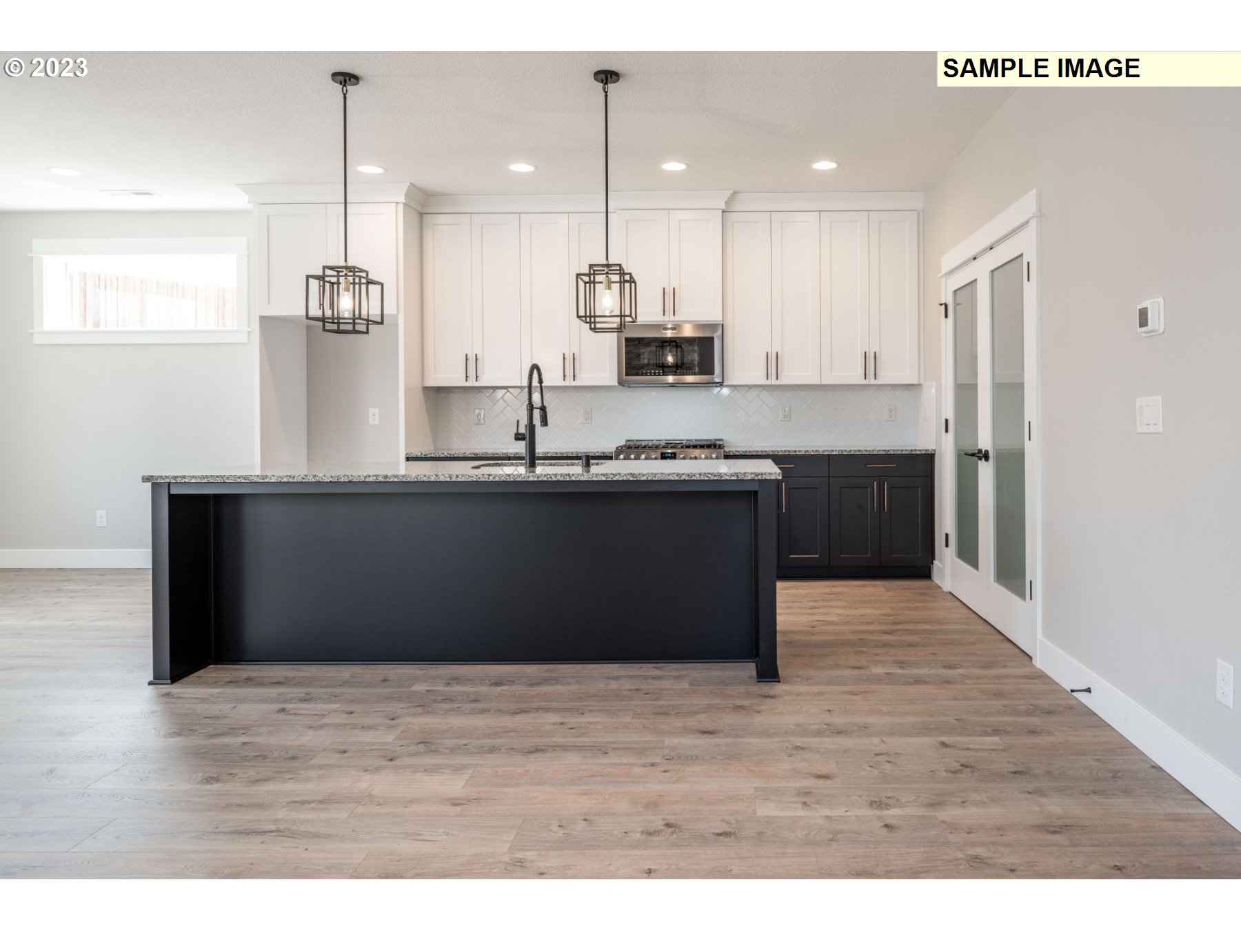 1101 South 46th Place Ridgefield, WA 98642 - Photo 6 of 22 a kitchen with kitchen island sink refrigerator and cabinets