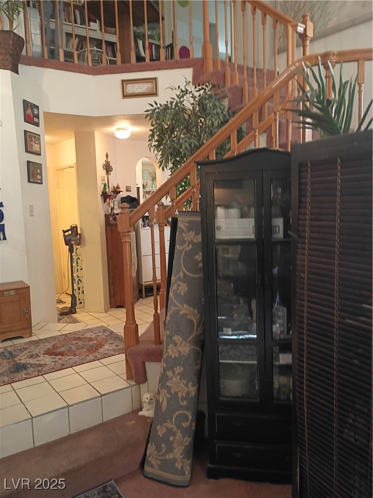 934 Derringer Lane Henderson, NV 89014 - Photo 14 of 49 Staircase with tile patterned flooring and a towering ceiling pot shelves