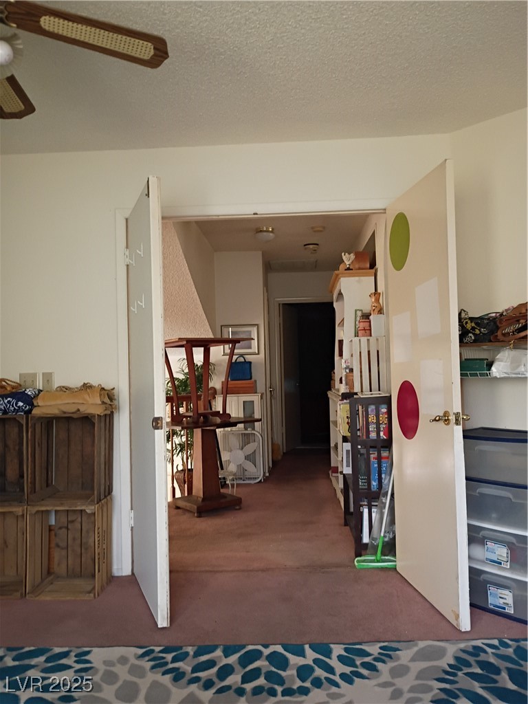 934 Derringer Lane Henderson, NV 89014 - Photo 33 of 49 Corridor with a textured ceiling and carpet flooring upstairs
