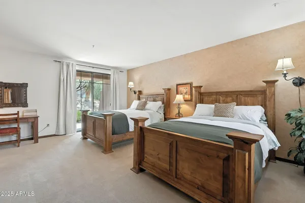 a bed room with two bed and a night stand