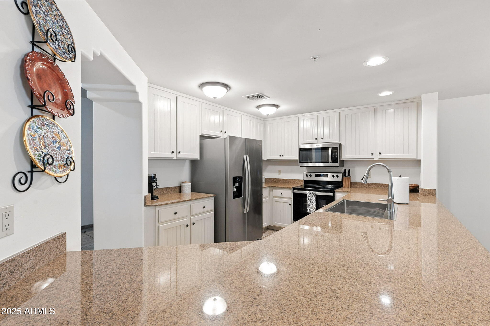 36601 North Mule Train Road, Unit B19 Carefree, AZ 85377 - Photo 16 of 48 a kitchen with granite countertop a refrigerator stove and sink
