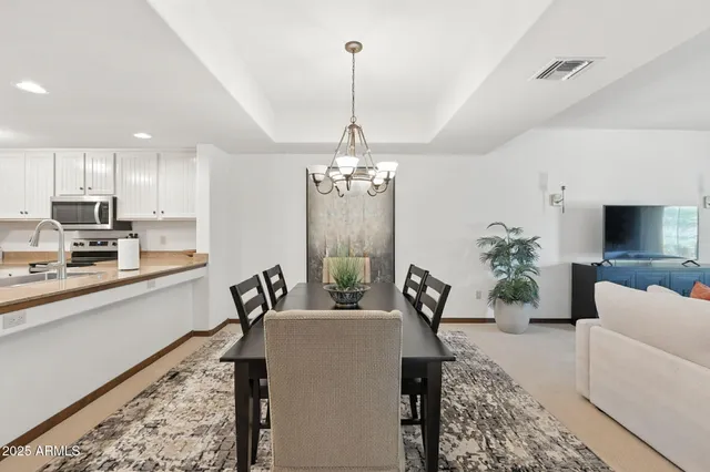 a view of a yard with plants and trees