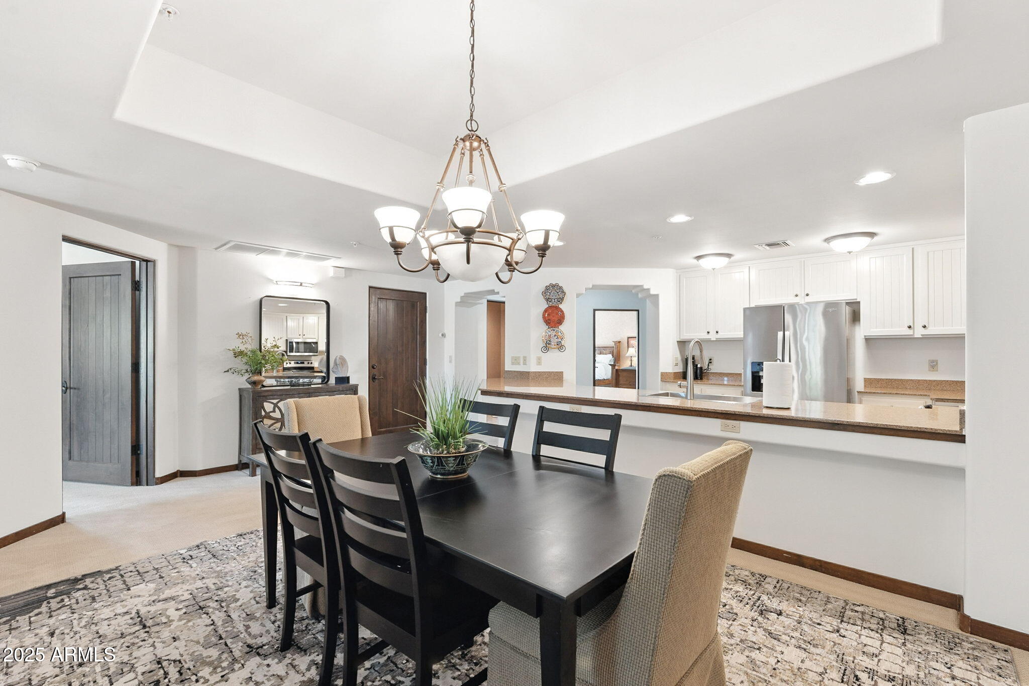 36601 North Mule Train Road, Unit B19 Carefree, AZ 85377 - Photo 21 of 53 a dining room filled chandelier and kitchen view