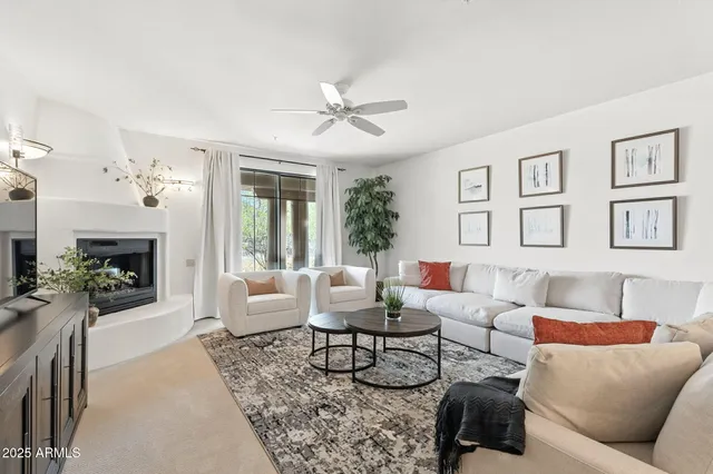 a living room with furniture and a view of kitchen