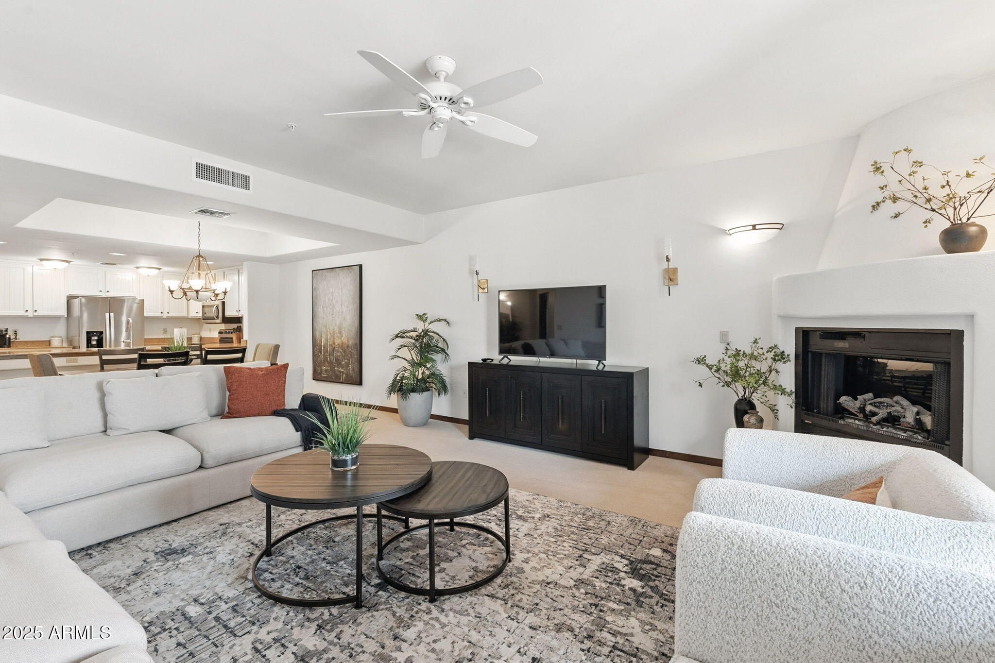 36601 North Mule Train Road, Unit B19 Carefree, AZ 85377 - Photo 27 of 53 a living room with furniture a fireplace and a flat screen tv