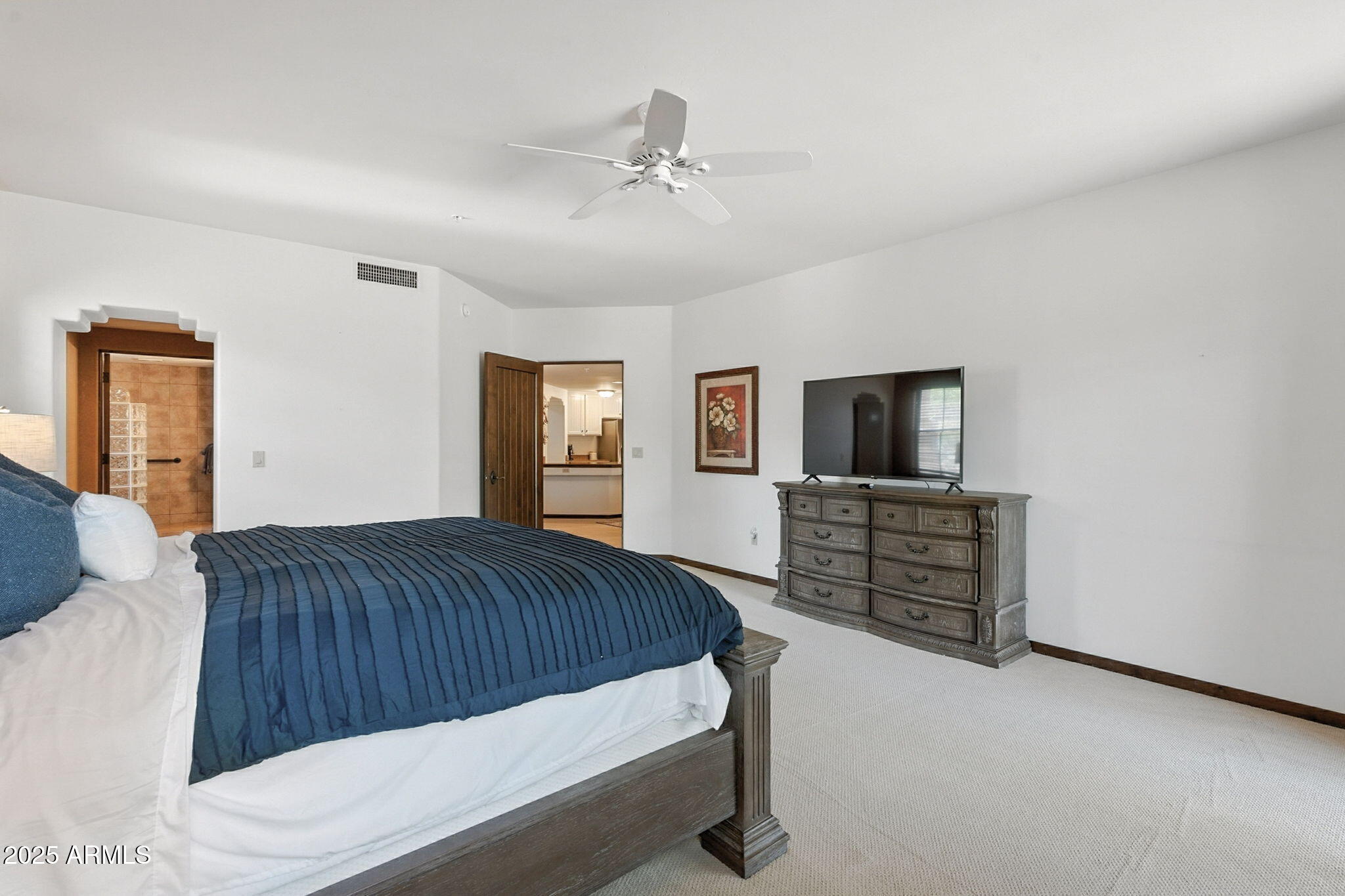 36601 North Mule Train Road, Unit B19 Carefree, AZ 85377 - Photo 40 of 53 a bedroom with a large bed and a flat screen tv