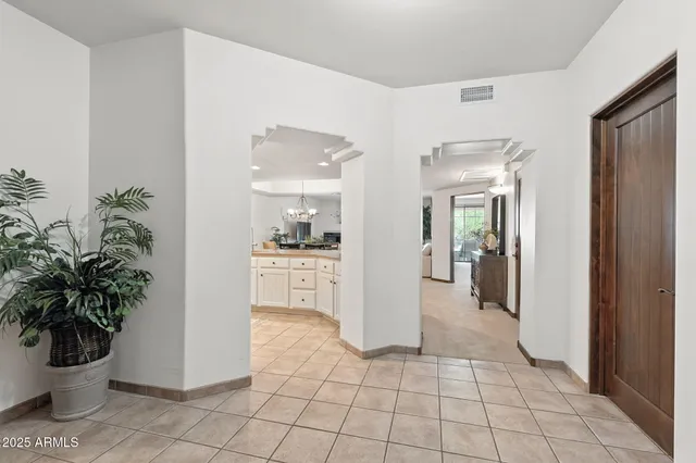 a living room with furniture and a view of kitchen