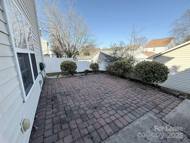 a view of a backyard with a large tree