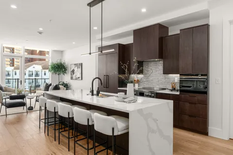 a kitchen with granite countertop a sink stainless steel appliances and cabinets