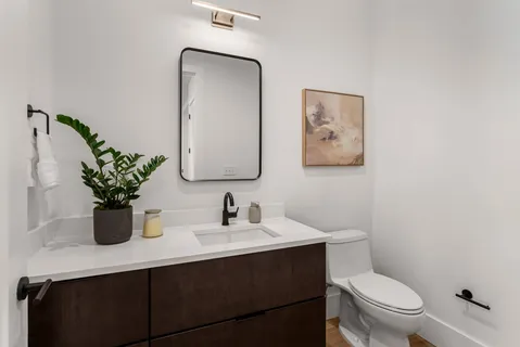 a bathroom with a sink vanity and a mirror