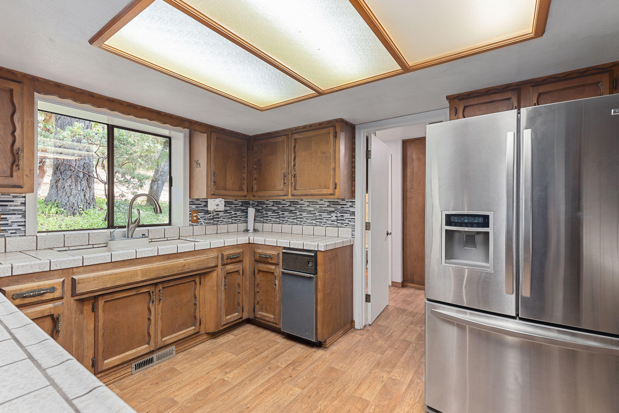 8860 Lower River Road Grants Pass, OR 97526 - Photo 8 of 48 a kitchen with stainless steel appliances granite countertop a refrigerator and a sink
